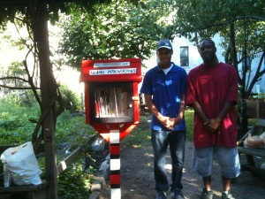 Rayquan Winchester and Christopher Dotson after planting and painting the Little Free Library in the Harlem Success Garden. They will plant two more in Marcus Garvey Park this spring.