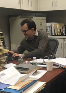 James working at his desk in Poly Prep.