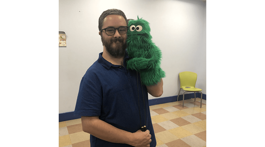 Jon with a green puppet.