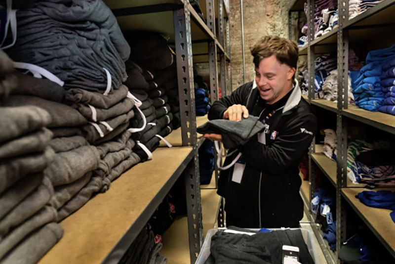 David working at the NBA store storing clothing.