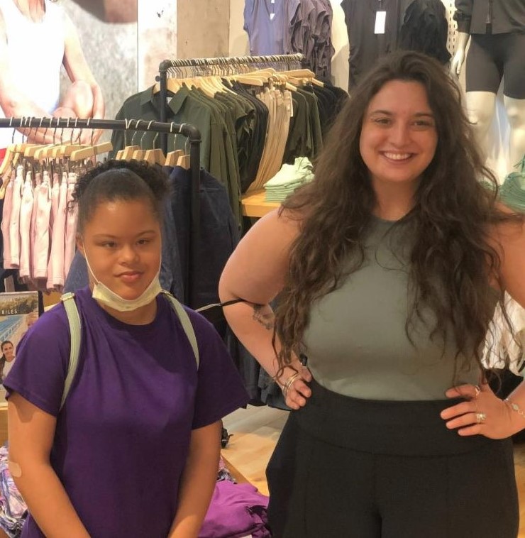 Photo of Erica and her employment specialist, Lizy, inside the clothing store Athleta