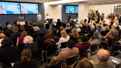 Photo of the main room at the 2023 benefit. The audience is seated, waiting for Carly Teichman to begin the presentation.